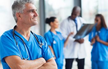 Smiling Doctor with Other Doctors in Background